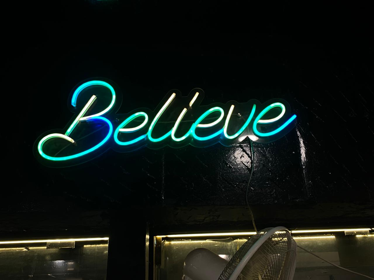 Iconic neon Believe sign at Kratos Fitness